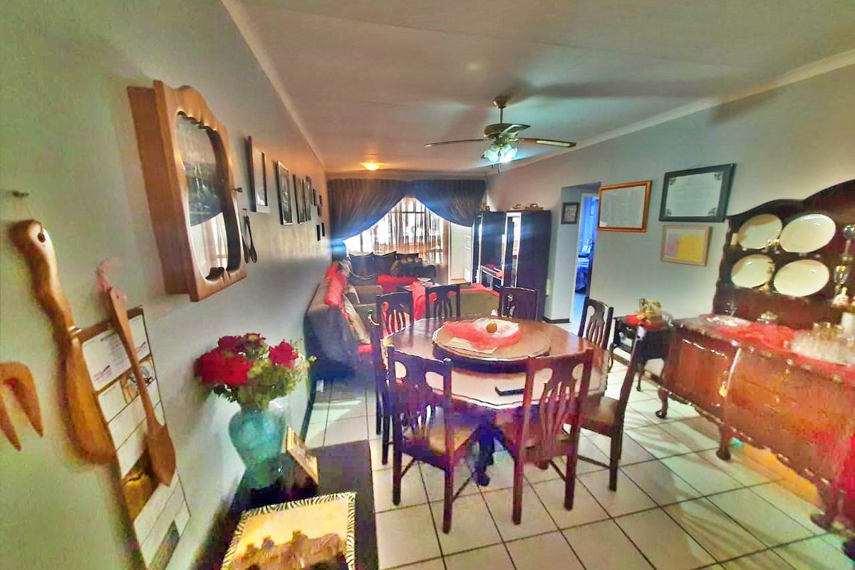 Open plan living and dining area featuring tiled flooring and a ceiling fan, providing a functional space for daily living.