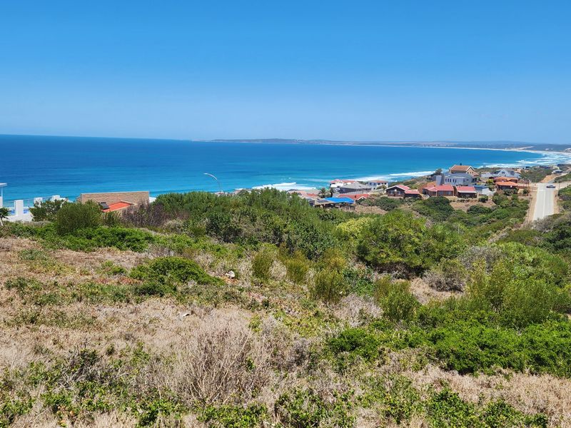 A scenic view of the coastline and surrounding residential area from the vacant residential land.