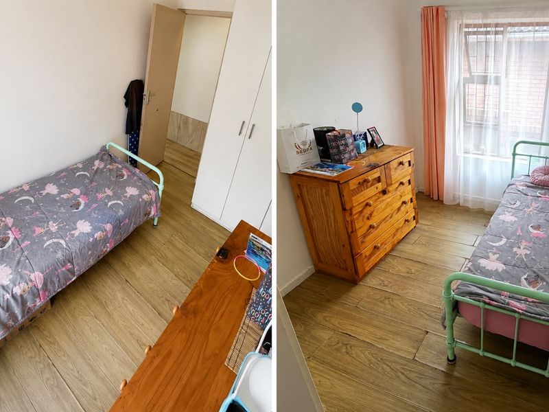 A compact bedroom featuring laminate flooring and a built-in wardrobe, offering a functional space with natural light.