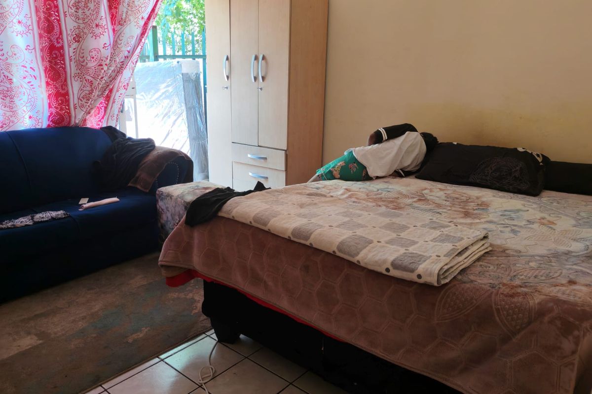 A bedroom featuring tiled flooring and a built-in wardrobe, with direct access to an outdoor area.