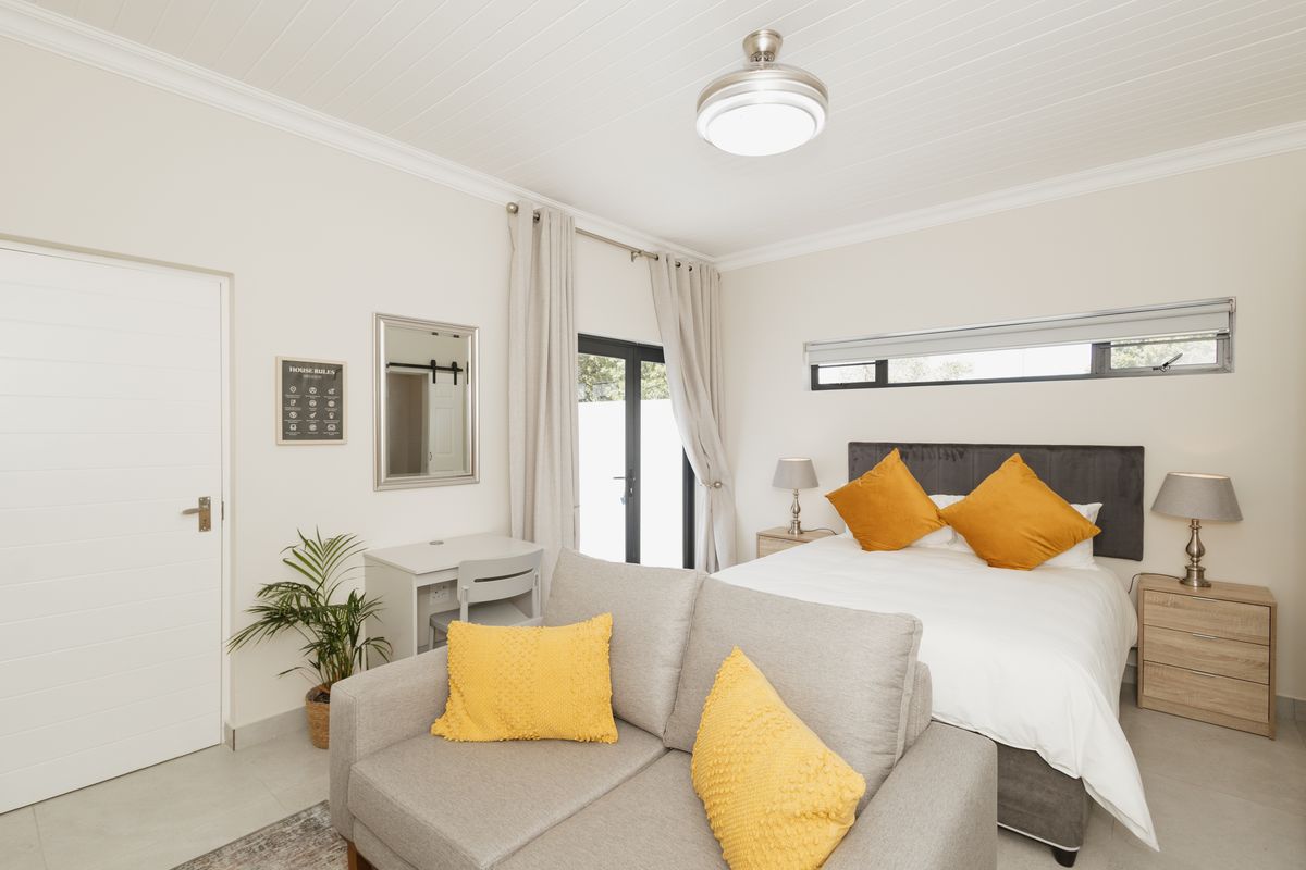 A well-maintained bedroom featuring a tongue and groove ceiling, neutral walls, and direct access to an outdoor area through a glass panel door.