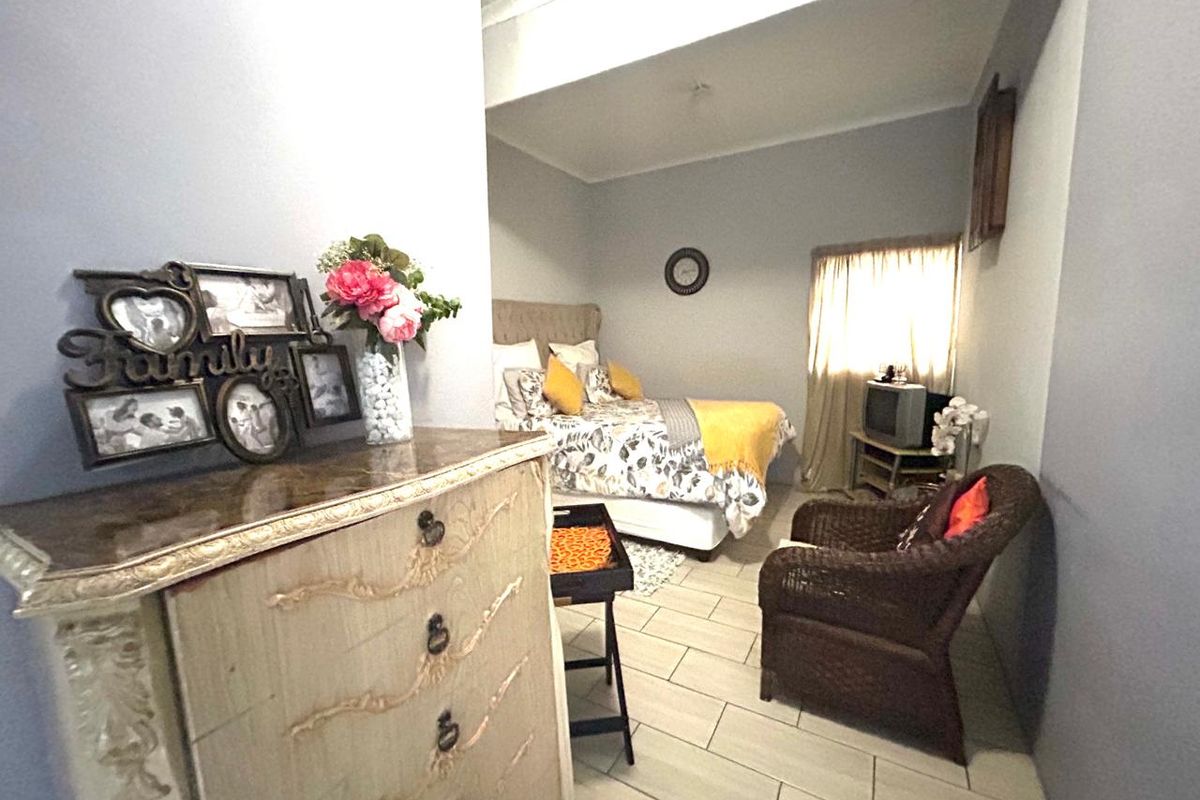A bedroom featuring tiled flooring and a coved ceiling, providing a functional living space.