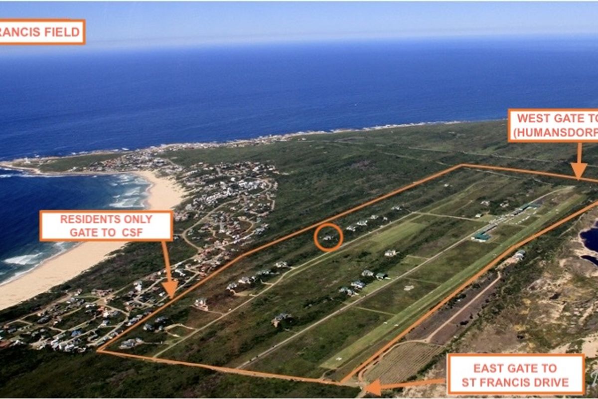 Aerial view of St Francis Field estate, highlighting the private airstrip, residential plots, and proximity to the coastline and main access gates.