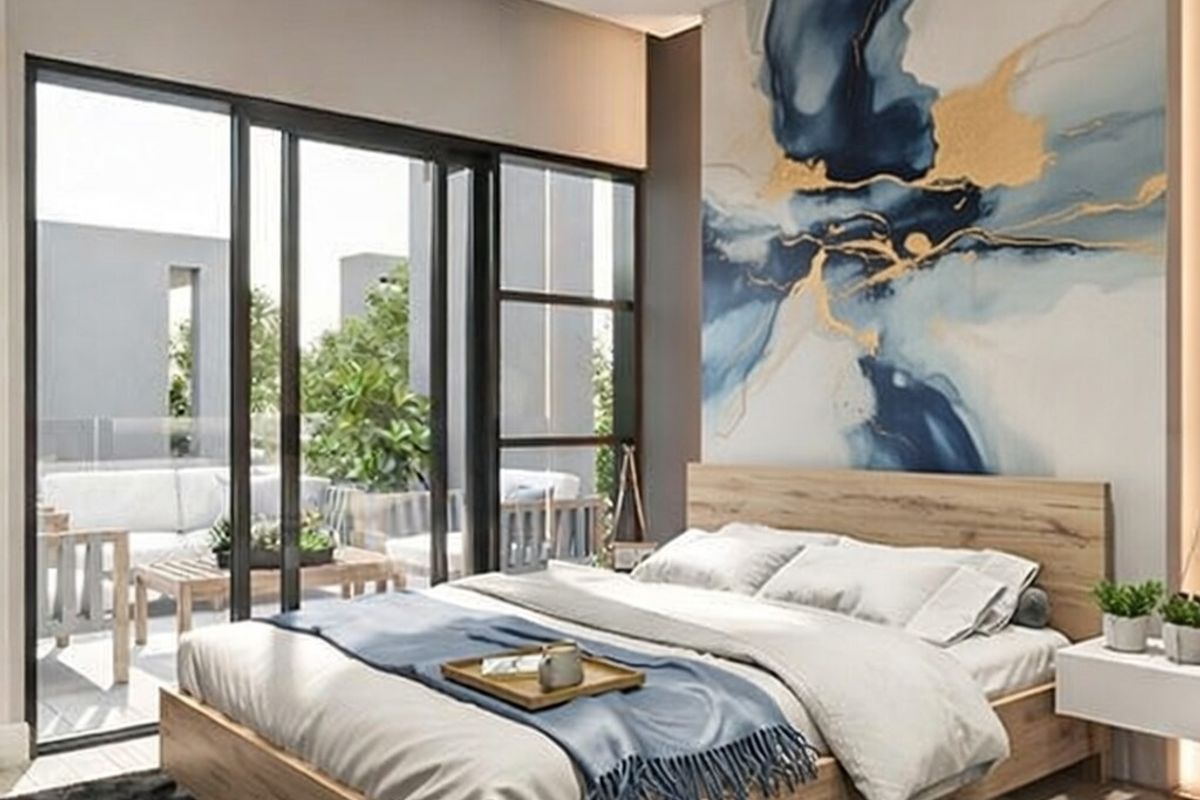 Modern bedroom featuring large sliding glass doors that open onto a private balcony, complemented by contemporary finishes and recessed lighting.
