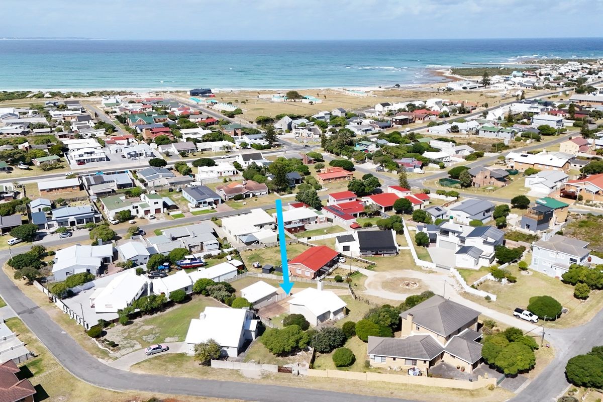 Aerial view of the property location within the coastal neighbourhood, highlighting the building footprint and proximity to the ocean.