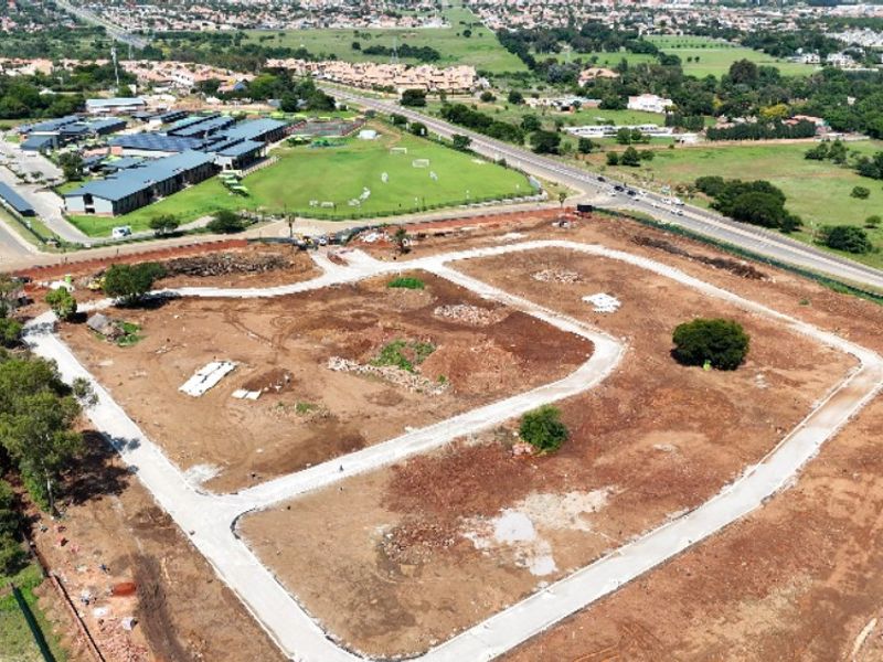 Aerial view of a residential development site featuring cleared land and newly constructed internal road infrastructure.