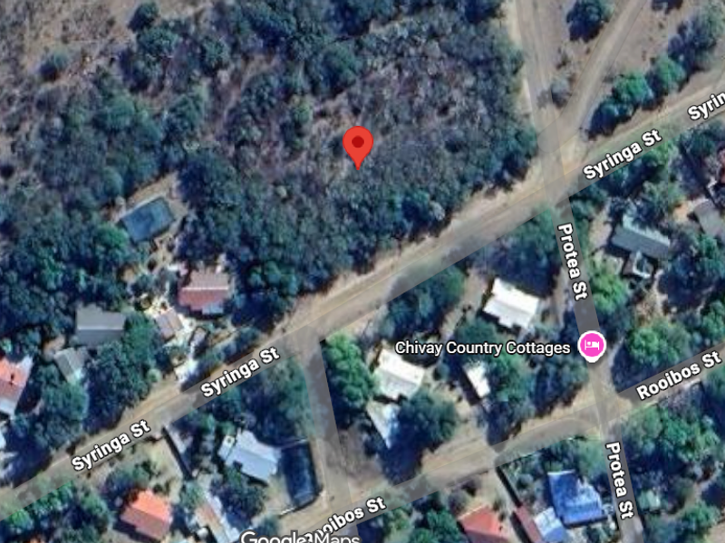 Aerial view of a vacant residential plot located at the intersection of Syringa Street and Protea Street.