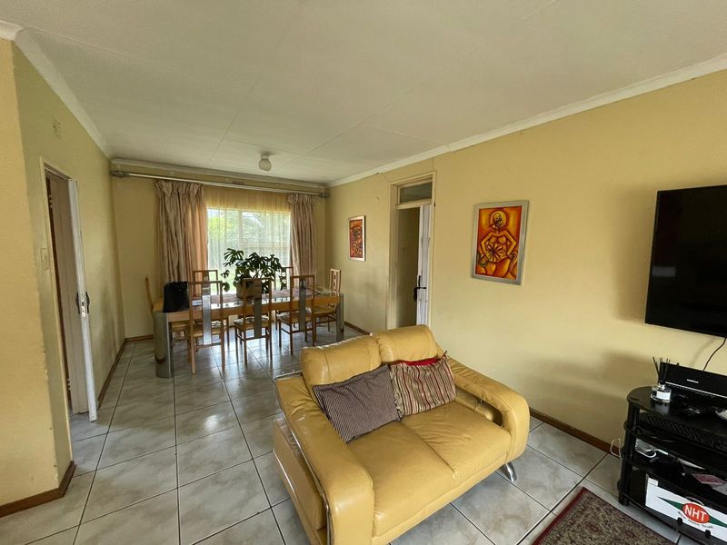 Open plan living and dining area featuring tiled flooring and neutral wall finishes, providing a functional space for daily living and entertaining.