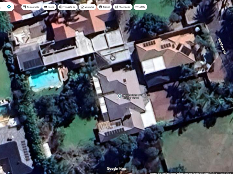 Aerial satellite view of the residential property showing the roof structure, swimming pool, and surrounding garden area.