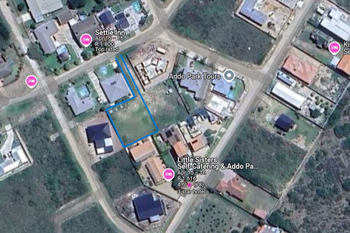 Aerial view of a vacant residential plot situated within an established neighborhood, highlighting the property boundaries and surrounding local infrastructure.