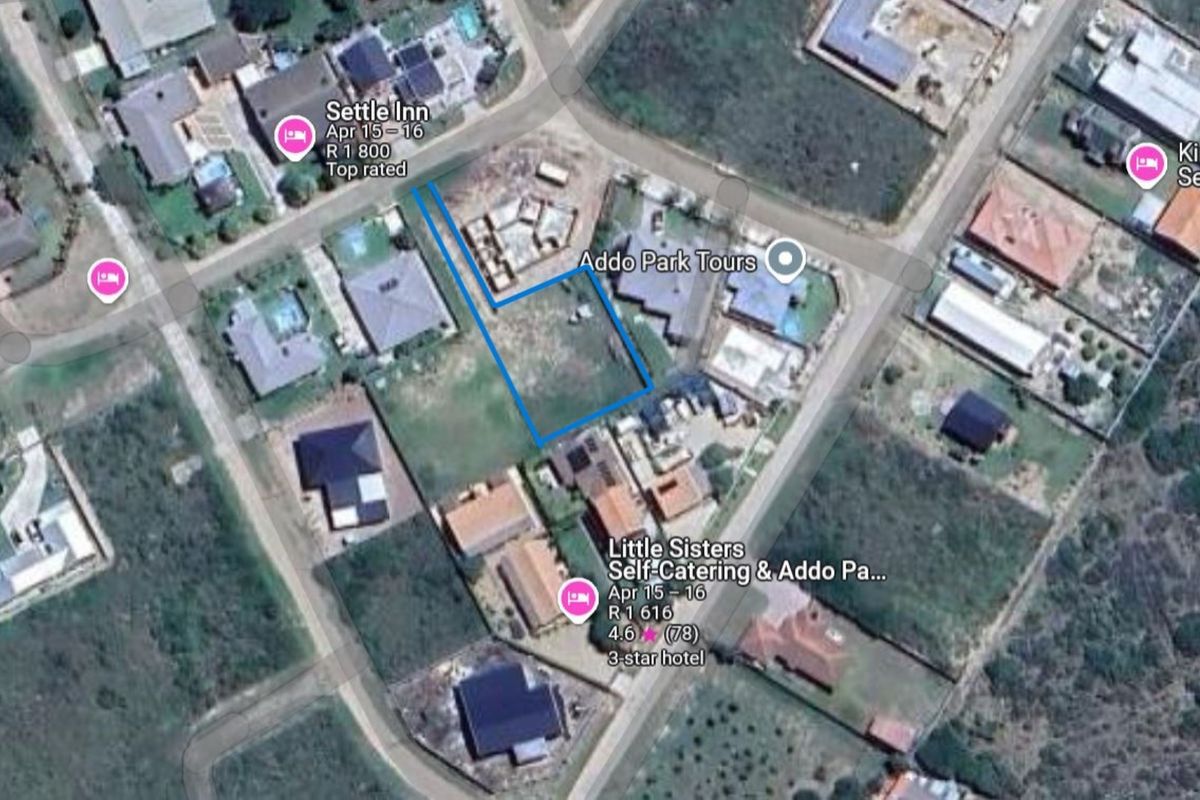 Aerial view of a vacant residential plot situated within a developed neighborhood, highlighting the property boundaries and surrounding infrastructure.