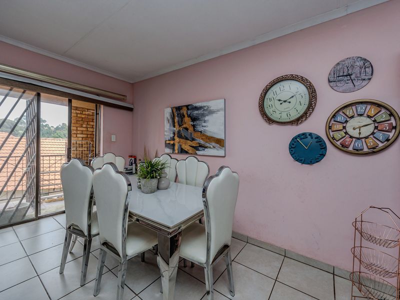 Dining area featuring ceramic floor tiles and a sliding glass door providing access to an outdoor balcony space.