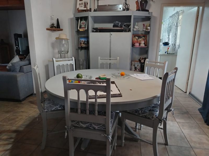 A dining area featuring tiled flooring and a built-in storage unit, providing a functional space for meals and gatherings.