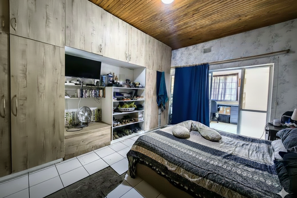 Bedroom featuring extensive built-in cabinetry, timber-clad ceiling, and direct access to an outdoor area through sliding glass doors.