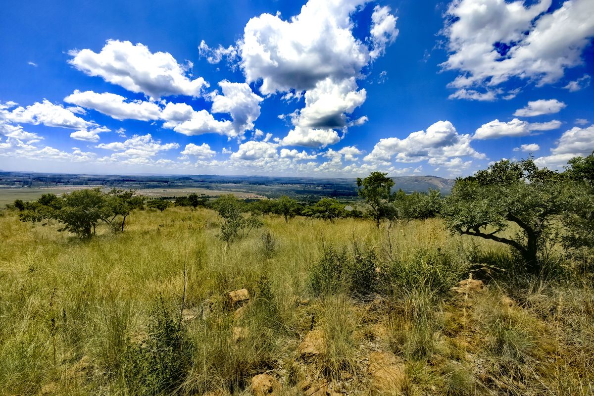 A scenic, elevated view overlooking the natural landscape and surrounding terrain, showcasing the property's expansive outdoor setting.