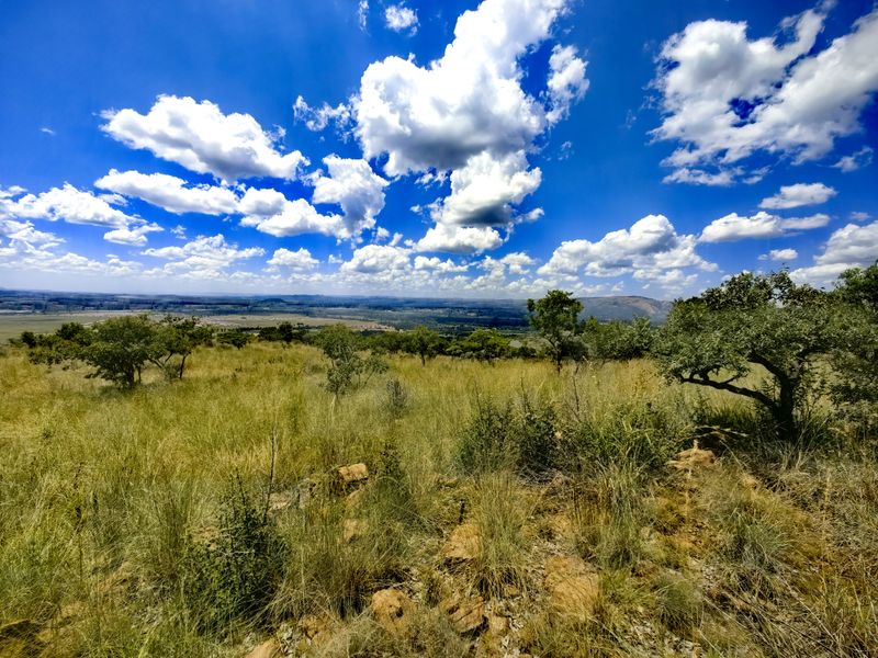 A scenic, elevated view overlooking the natural landscape and surrounding terrain, showcasing the property's expansive outdoor setting.