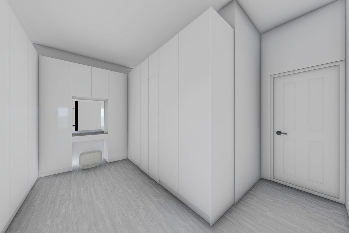 A modern, minimalist walk-in closet or dressing area featuring extensive built-in cabinetry, a dedicated vanity station, and light-toned laminate flooring.