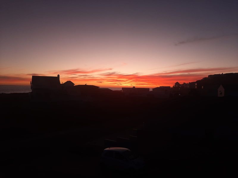 A scenic sunset view overlooking the coastal residential landscape and horizon.