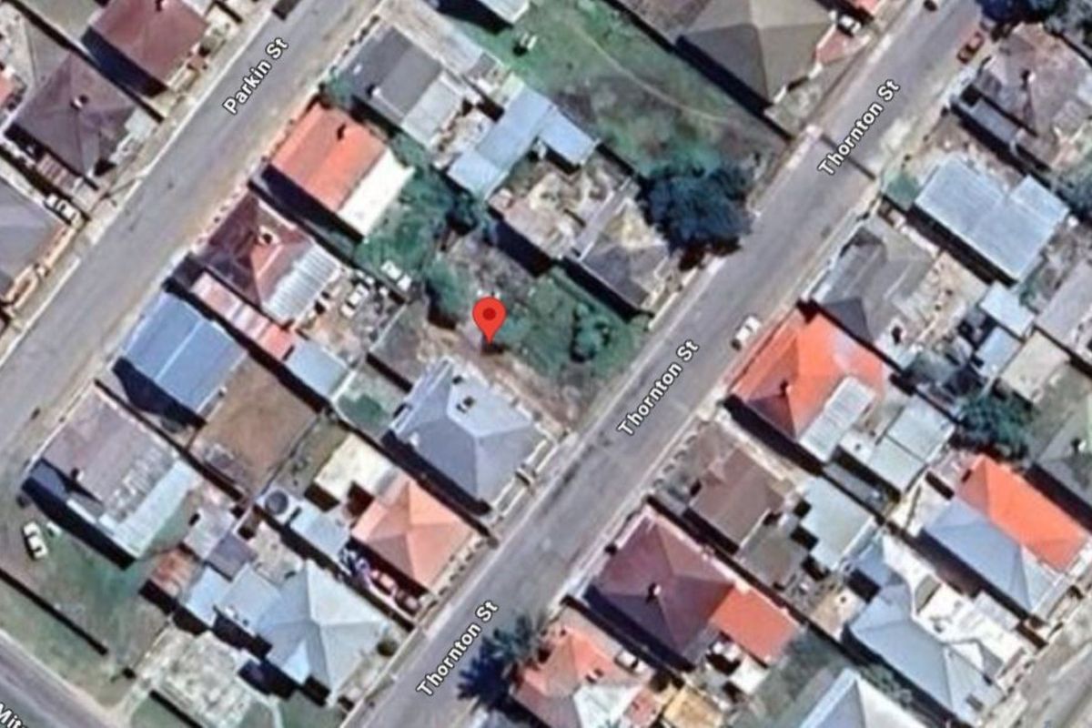 Aerial view of a vacant residential plot located on Thornton Street, surrounded by established neighborhood housing.