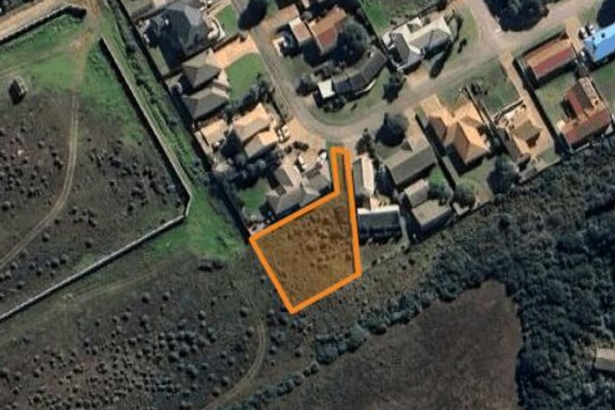 An aerial view showing the vacant residential land plot highlighted in a suburban neighborhood setting.