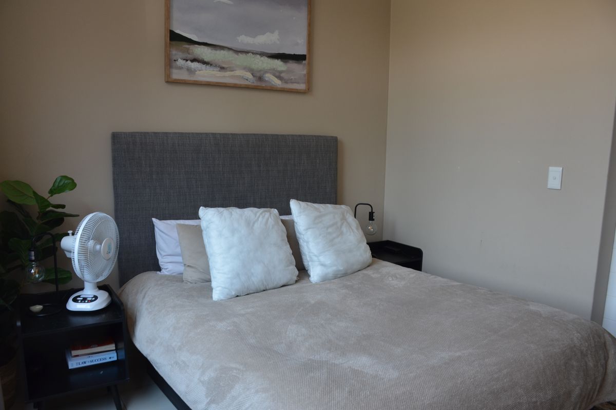 A well-maintained bedroom featuring neutral wall tones and a clean, functional layout.