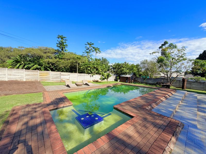 Outdoor pool area featuring a swimming pool with brick paving and perimeter walling, requiring maintenance to the water quality and surrounding surfaces.