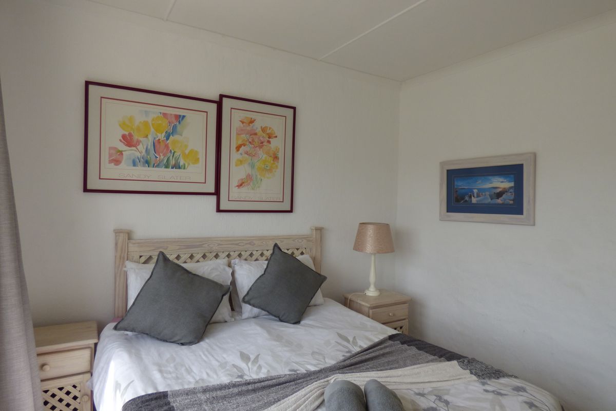 A standard bedroom featuring neutral walls and a simple layout, suitable for a comfortable sleeping space.