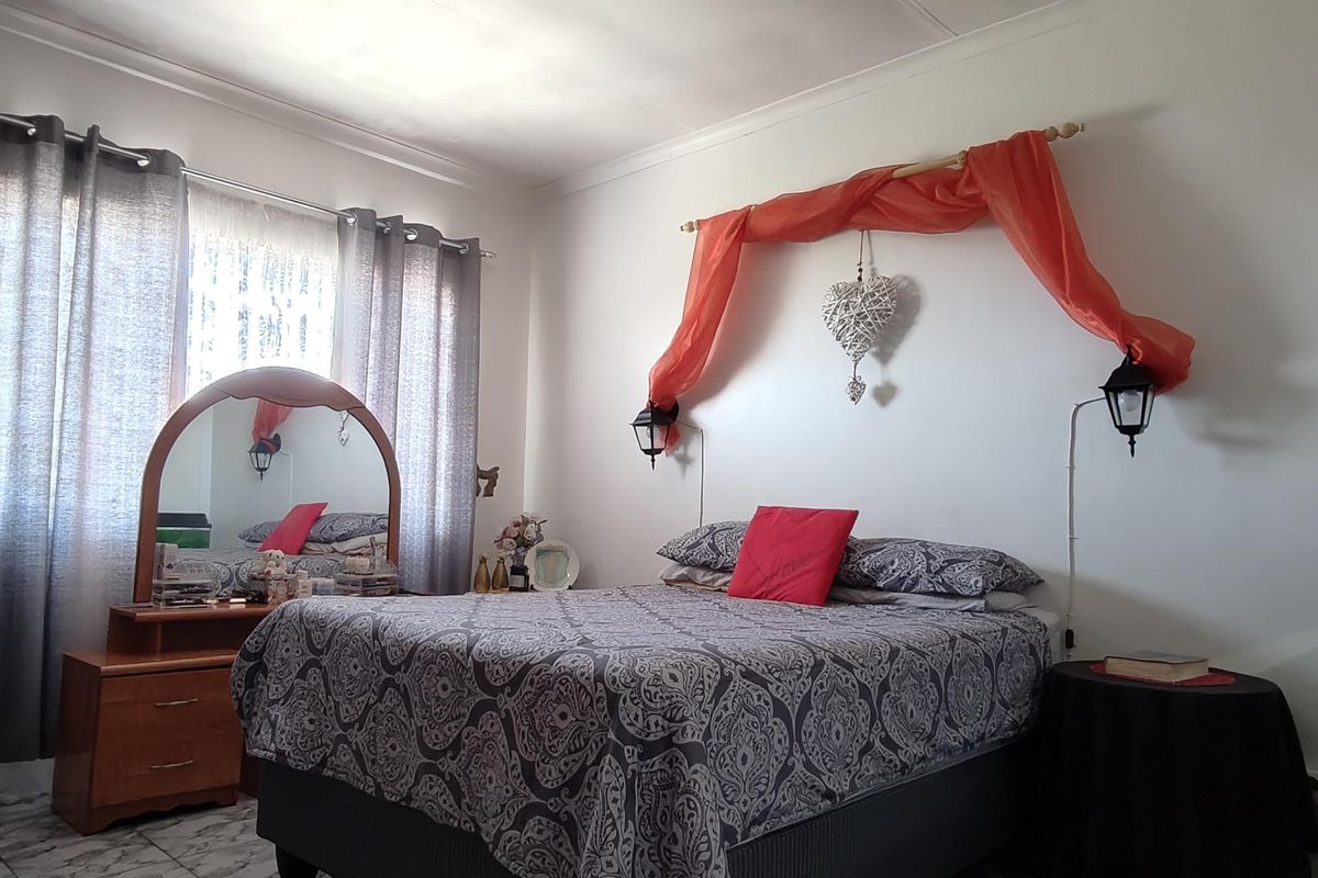 A bedroom featuring tiled flooring and coving, providing a functional space ready for personalization.
