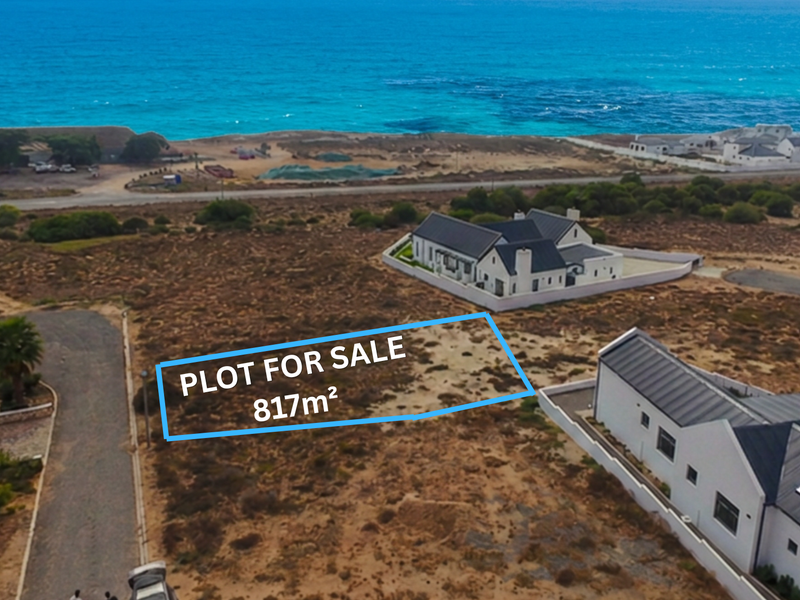 An aerial view of an 817m² vacant residential plot situated in a coastal estate, offering proximity to the ocean.