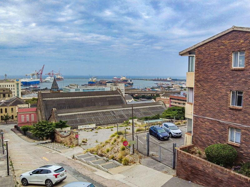 An elevated view overlooking the surrounding urban area, harbour, and industrial port facilities from the property.
