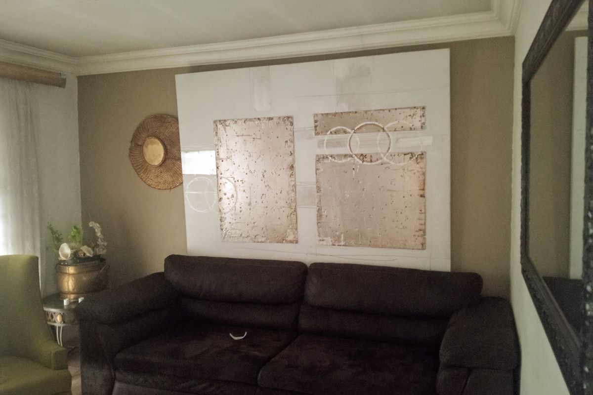 A living room space featuring crown molding and neutral wall tones, providing a comfortable area for relaxation.