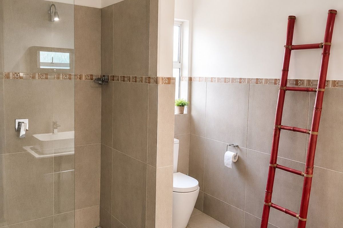 Modern bathroom featuring a glass-enclosed walk-in shower with mosaic tiling, a separate toilet area, and a contemporary vessel sink vanity.