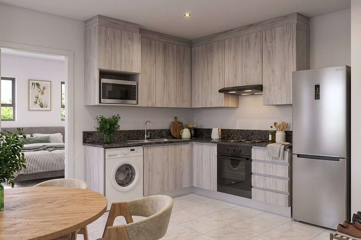 Modern kitchen featuring light wood-grain cabinetry, stone countertops, integrated appliances, and tiled flooring, seamlessly connected to the adjacent living and bedroom areas.