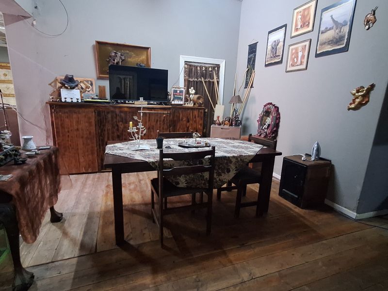 A dining area featuring original timber flooring and neutral wall finishes, providing a functional space for meals.