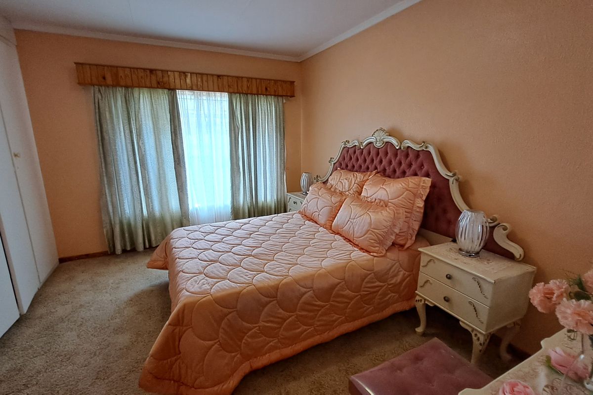 A bedroom featuring carpet flooring and a built-in wardrobe, offering a functional space with potential for modern updates.