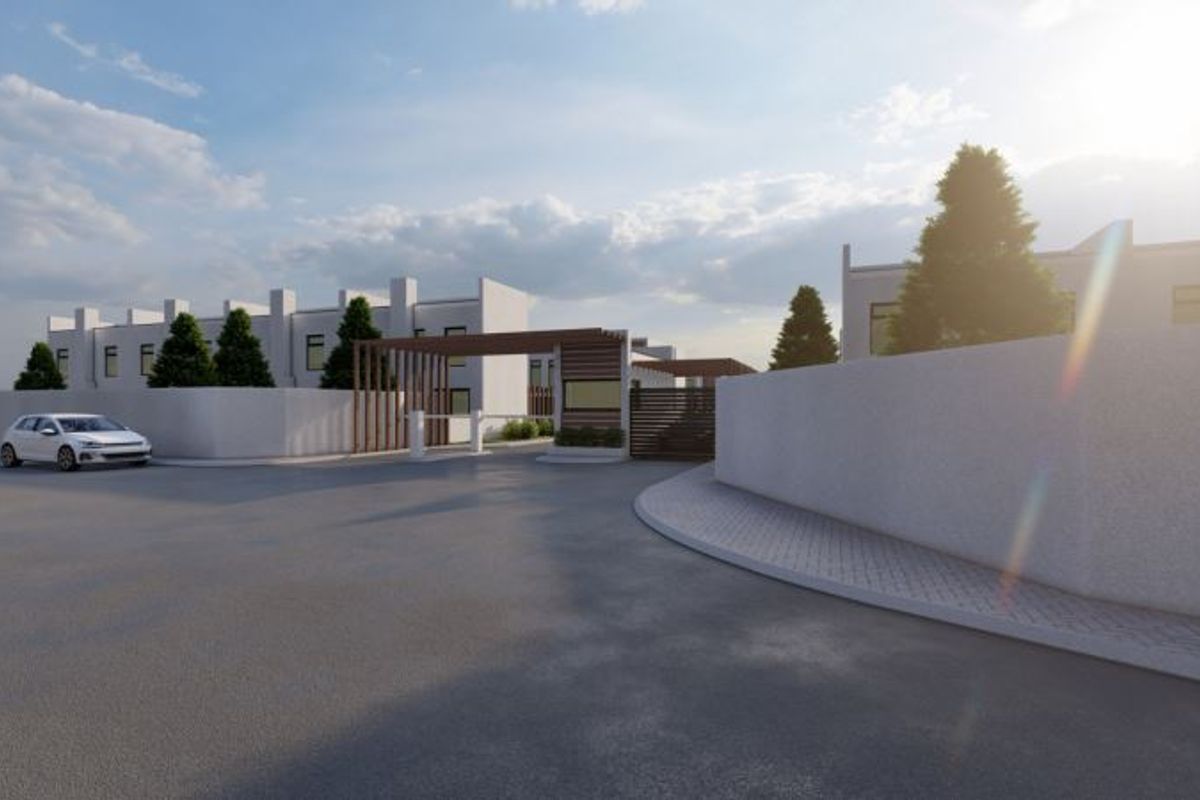 A modern residential complex entrance featuring a secure gated access point, timber pergola structure, and clean perimeter walling.