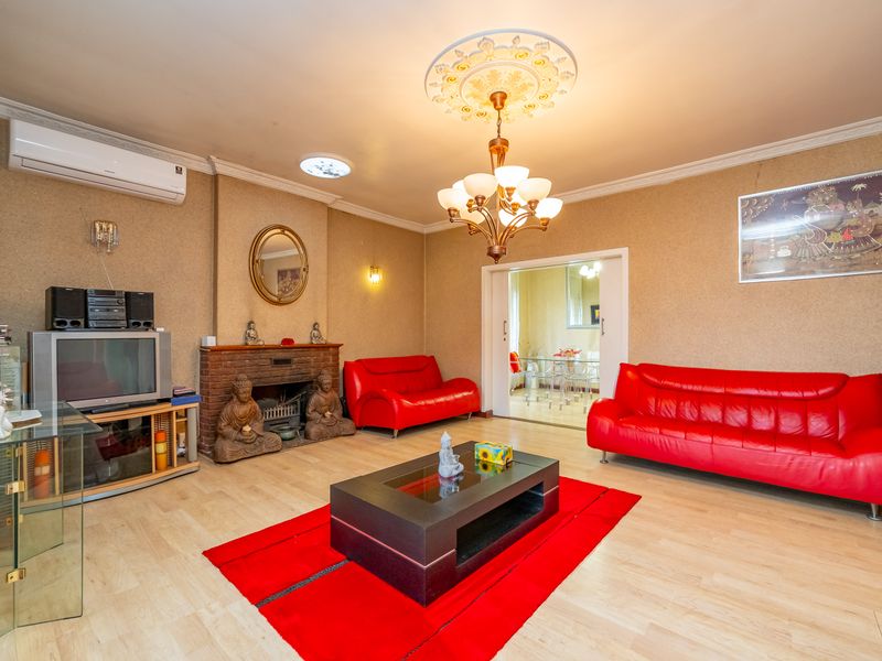 Spacious living room featuring a brick fireplace, split-system air conditioning, decorative ceiling rose, and sliding door access to the adjacent dining area.