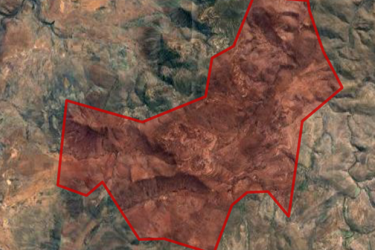 An aerial satellite view showing the demarcated boundary of the farm property within the surrounding landscape.