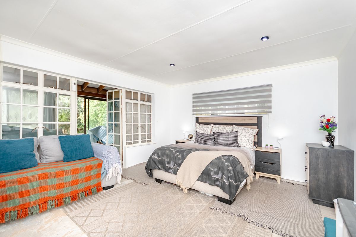 Spacious bedroom featuring recessed lighting and large multi-pane glass doors that provide direct access to the outdoor area.