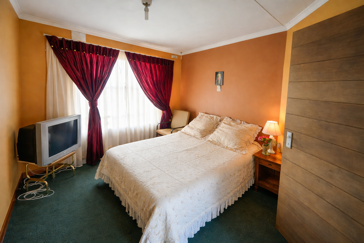 A bedroom featuring carpeted flooring, a sliding door, and cove cornicing, offering a functional space ready for modern updates.