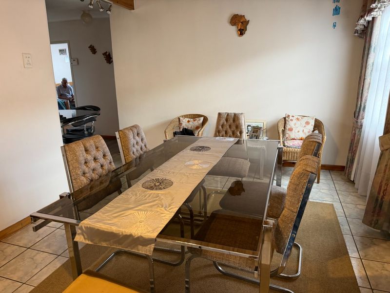 A dining room area featuring tiled flooring and neutral wall finishes, providing a functional space for family meals.