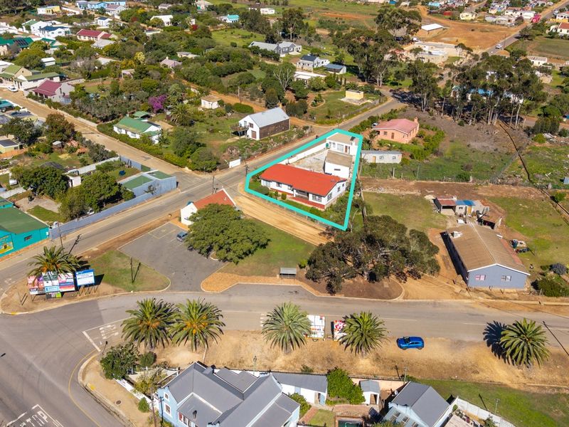 Aerial view of the property highlighting the building footprint, roof structure, and surrounding plot boundaries within the neighborhood context.
