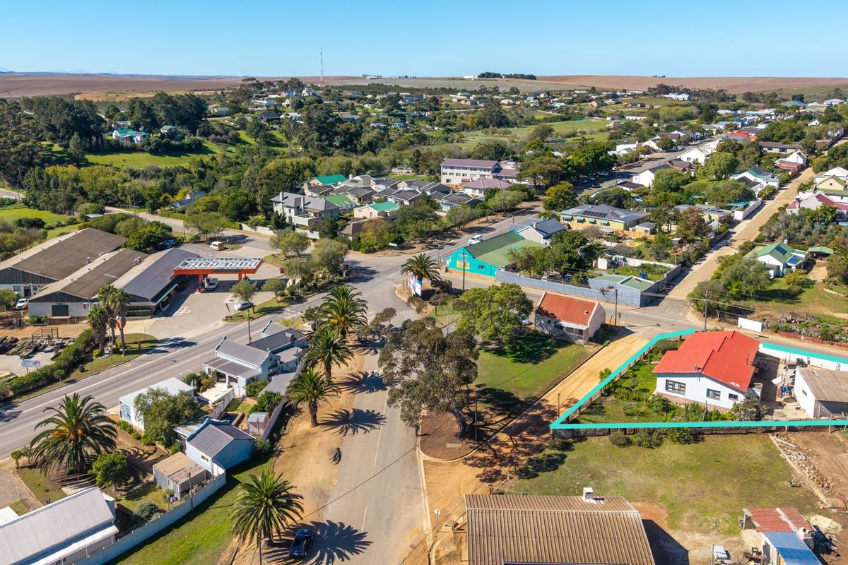 Aerial view of the property highlighting the building footprint, roof structure, and surrounding residential neighborhood context.