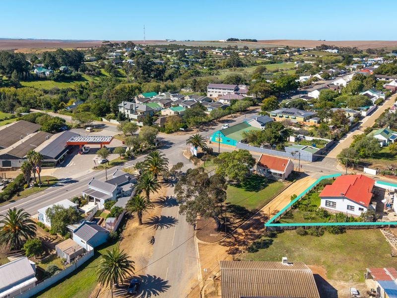 Aerial view of the property highlighting the building footprint, roof structure, and surrounding residential neighborhood context.