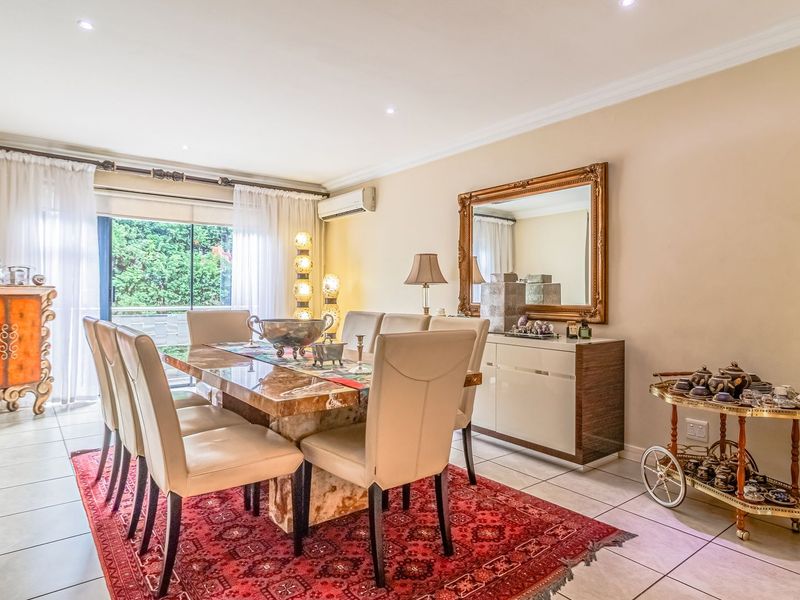 Spacious dining room featuring tiled flooring, recessed downlighting, and a sliding glass door providing access to the outdoor area.