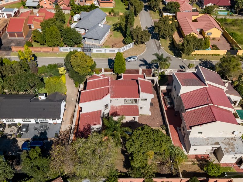 An aerial view of the residential property showing the roof structure, driveway, and surrounding neighbourhood layout.