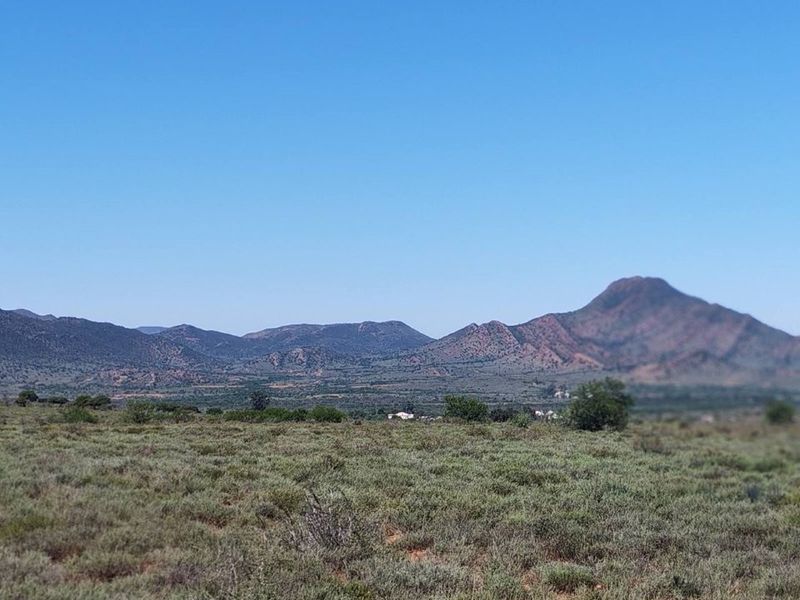 Expansive scenic view of the surrounding mountain range and natural landscape, showcasing the property's rural setting.