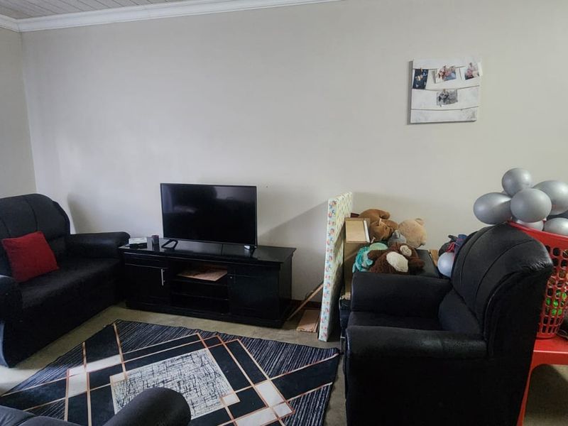 A living room area featuring a tongue and groove ceiling, providing a functional space for relaxation and entertainment.
