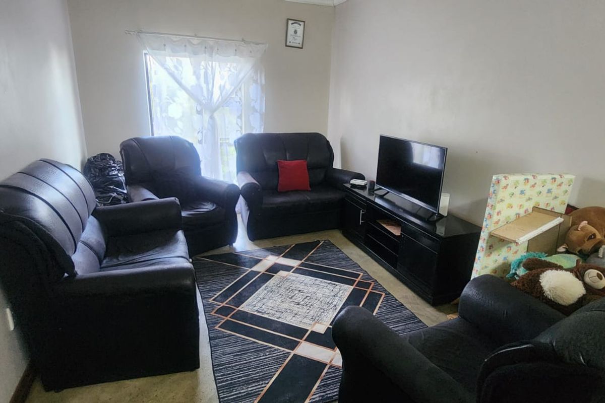 A living room area featuring a window and neutral wall finishes, providing a functional space for relaxation.