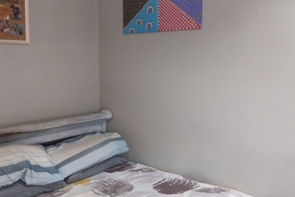 A bedroom corner featuring neutral wall finishes, suitable for personalization or staging to enhance the space's appeal.